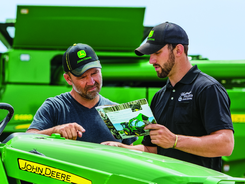 Heritage Tractor Salesman with customer discussing tractor
